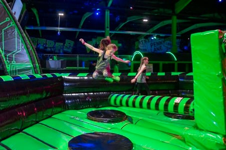 A child leaps to avoid the Ninja Wipeout at Flip Out UK
