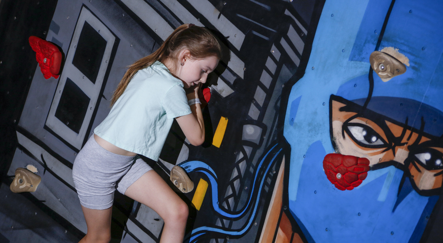 A child exploring the Traversing Wall at Flip Out UK