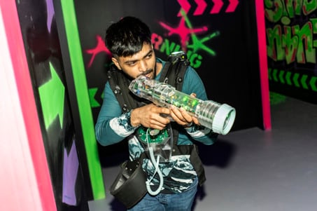 A man taking aim in the Laser Quest arena at Flip Out UK