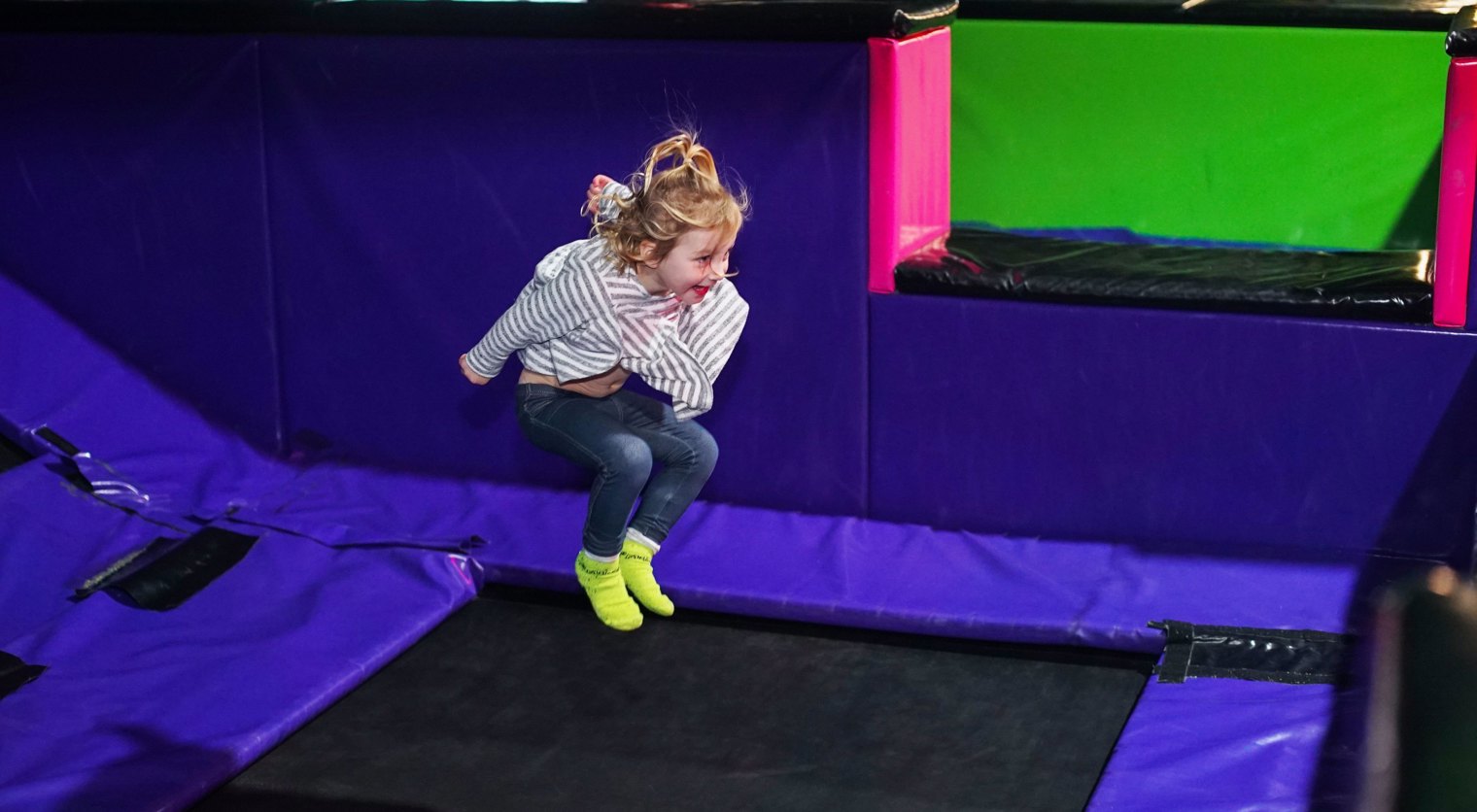 A small child bouncing in the Kids Stunt Zone at Flip Out UK