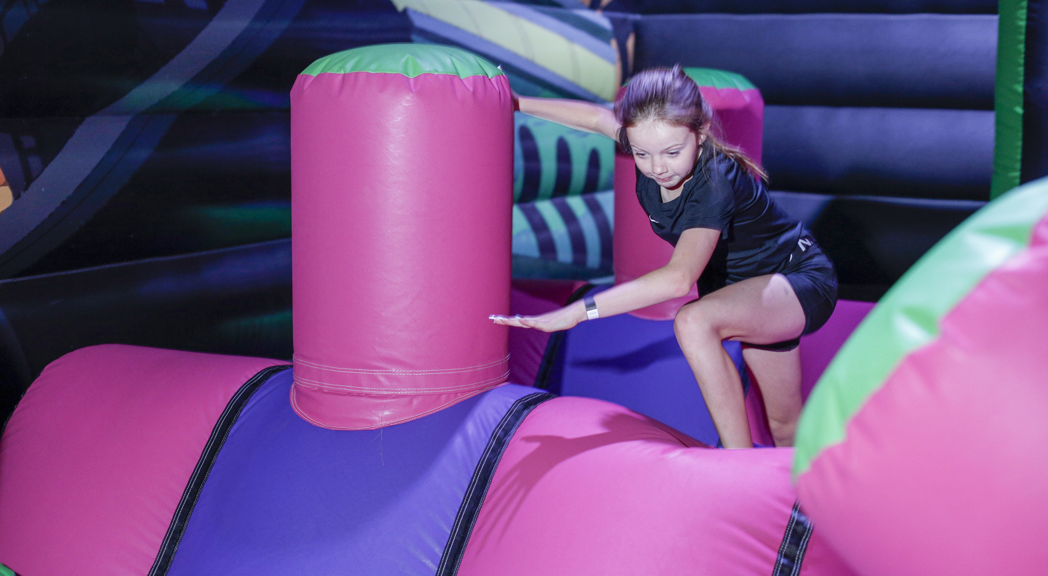 Children playing on an Inflatable Obstacle Course at Flip Out UK